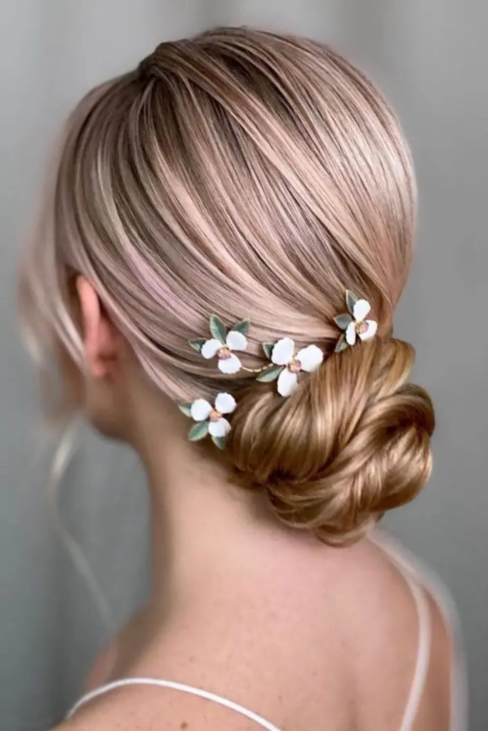 Sleek Low Bun with Loose Tendrils