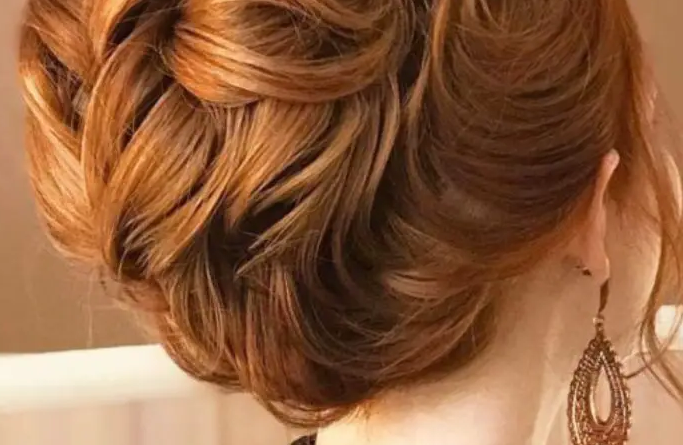 30. Twisted Copper Updo with Blonde Highlights