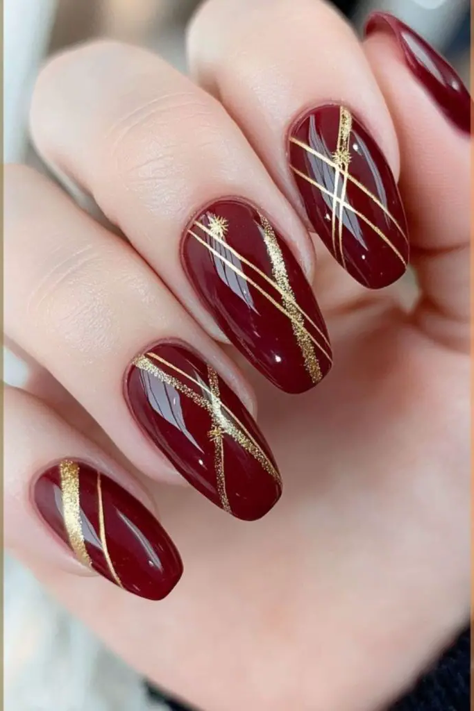 Glossy Red Nail Design with Gold Stripes